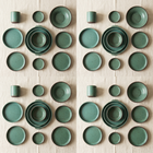 Ceramica Green Speckled Stoneware Dinnerware Set - overhead flat lay of plates, bowls and cups
